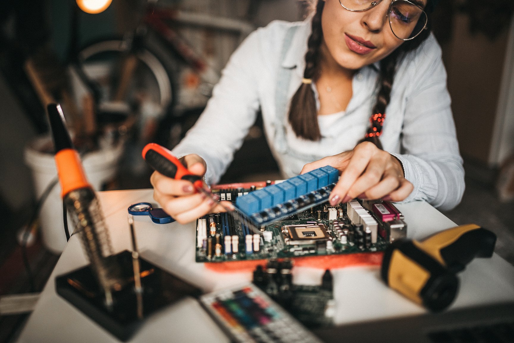 IT technician soldering circuit board